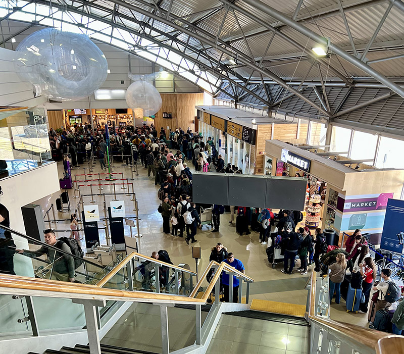 Lots of people standing in line at an airport